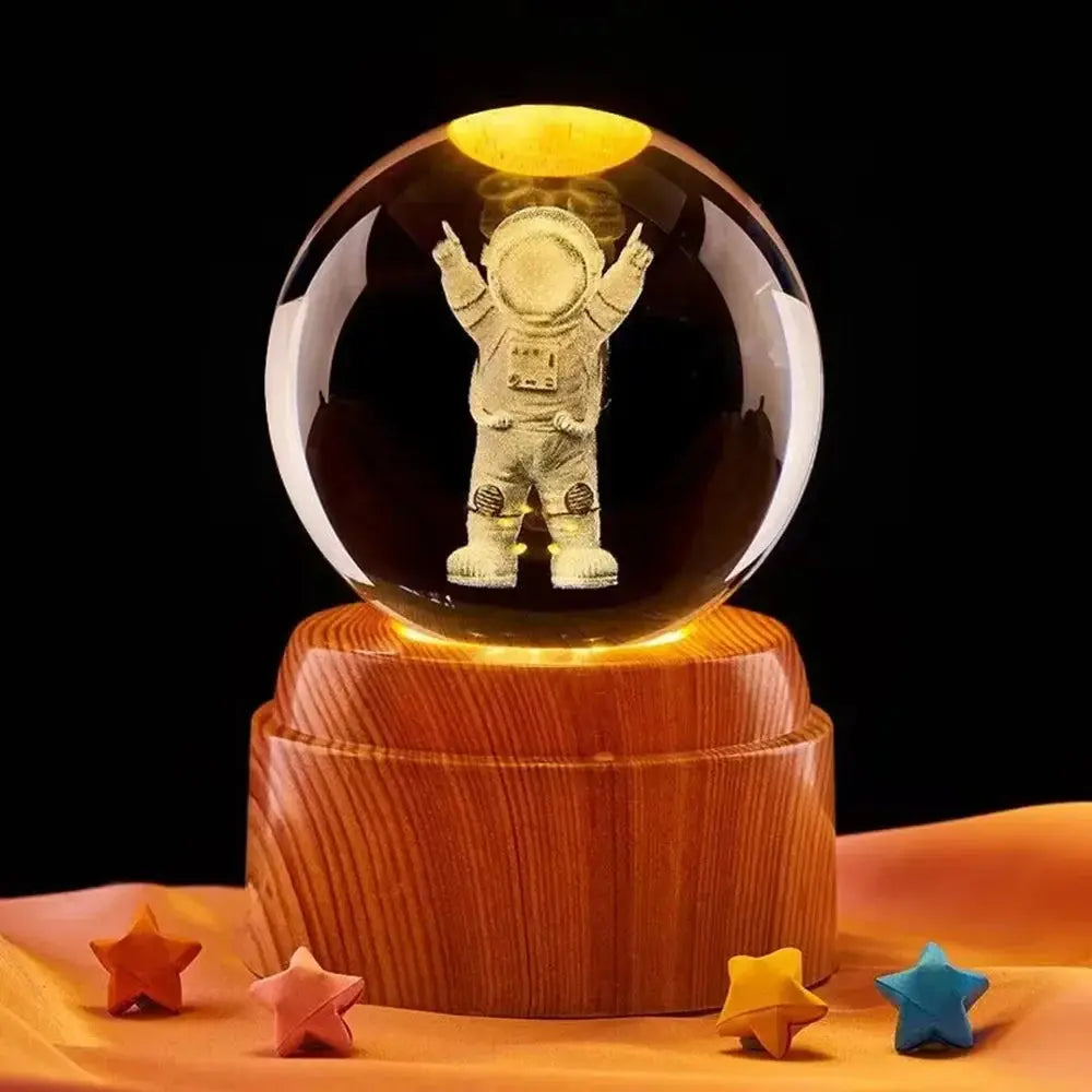 3D lunar design laser-etched in a crystal ball, softly illuminated on a wooden base for ambient lighting.