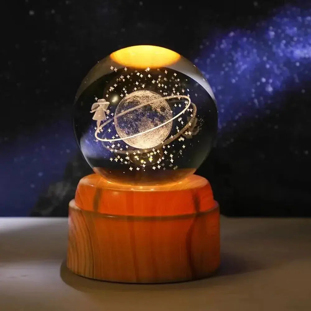 Laser-etched moon inside a glowing 3D crystal ball — decorative lamp with a warm wooden base.