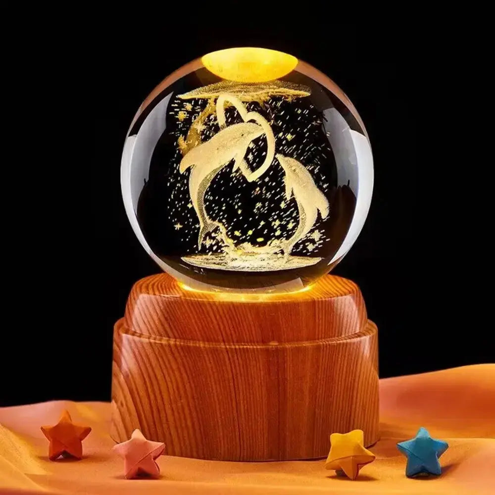 Elegant crystal lamp featuring a glowing full moon design, resting on a smooth wooden stand.