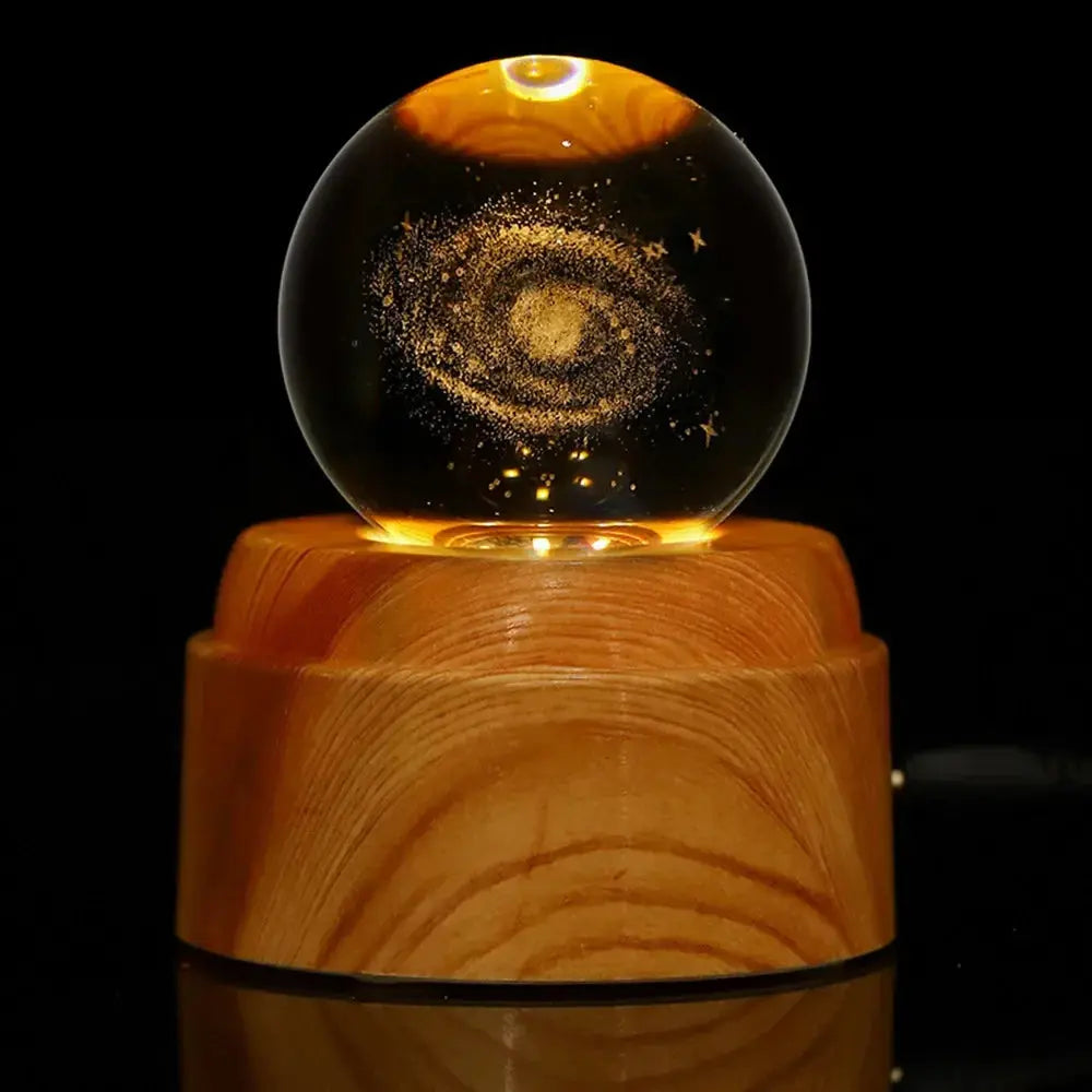 LED crystal globe lamp with a moon engraving, softly illuminated for relaxing ambient lighting.