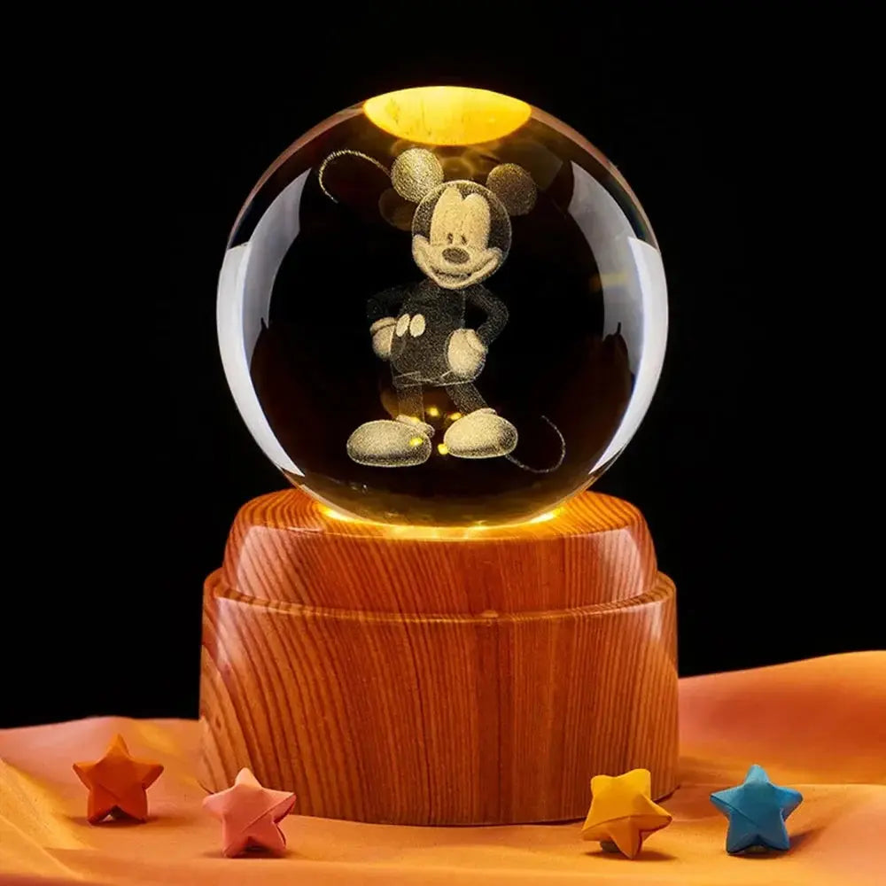 Decorative moon lamp with a 3D laser-etched design in crystal, radiating soft LED light on a wooden platform.