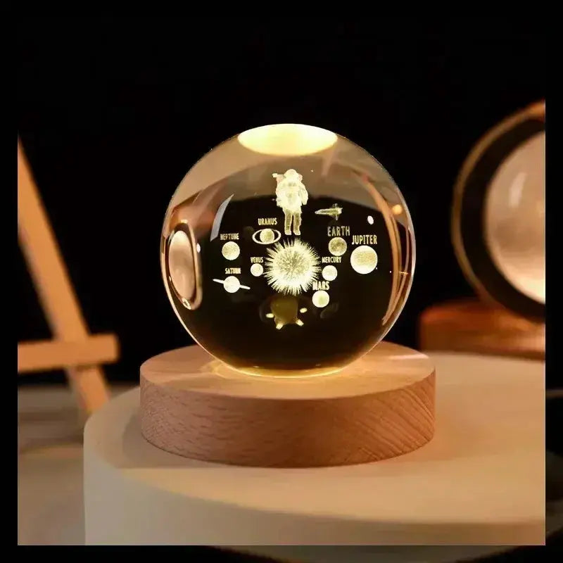 3D etched crystal lamp with a detailed solar system design, softly glowing on a wooden base — perfect for ambient home lighting and gifting.

