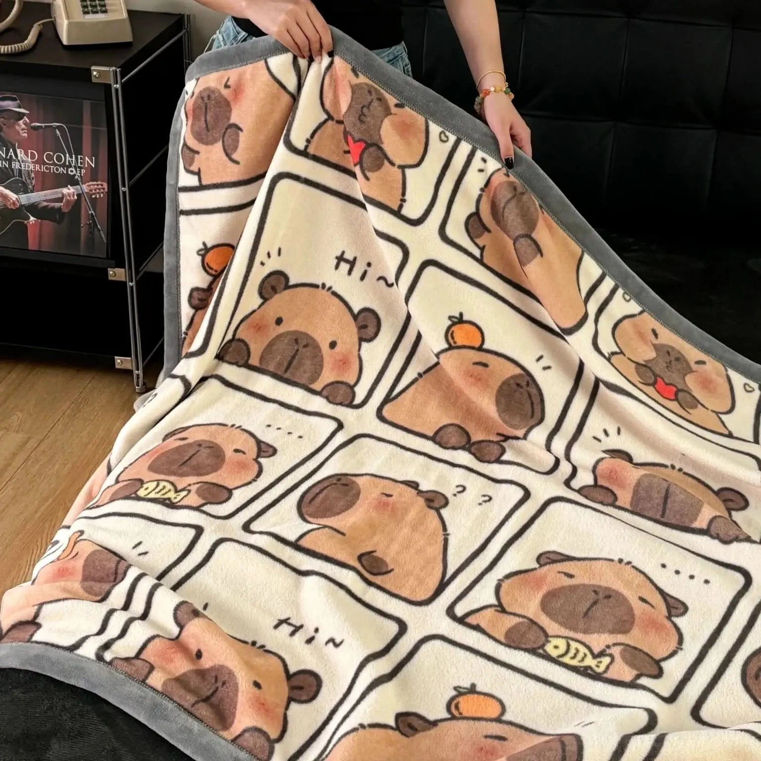 Lightweight bedding or sofa throw with charming capybara design and cosy texture.