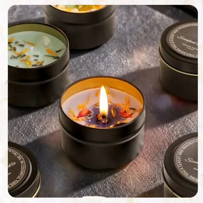 Elegant soy wax candle featuring dried botanicals and healing stones in a luxury iron tin.