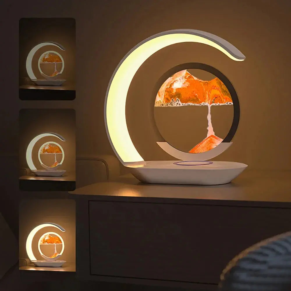 Modern LED desk lamp with a circular frame and floating sand art being positioned by a hand.

