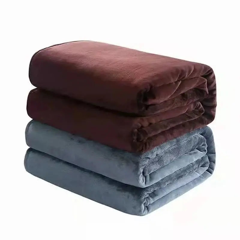 Plush coral fleece throw in luxurious flannel texture, ideal for layering over beds or sofas.

