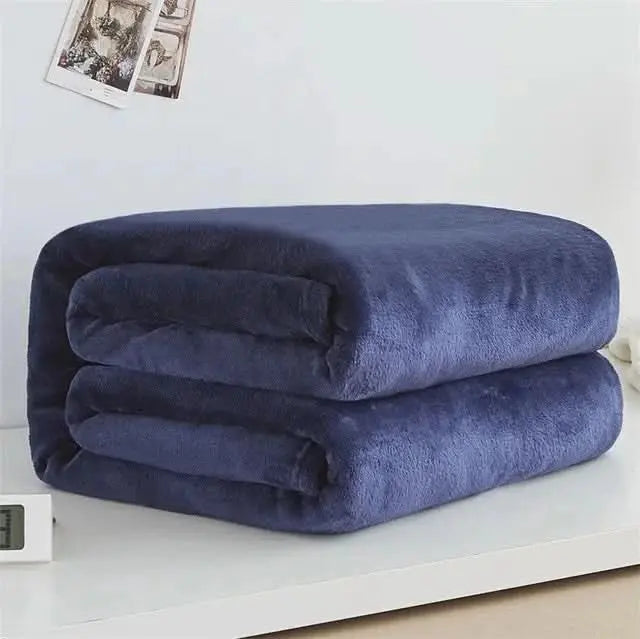 Smooth and ultra-soft blanket in coral fleece, a stylish touch for home décor.